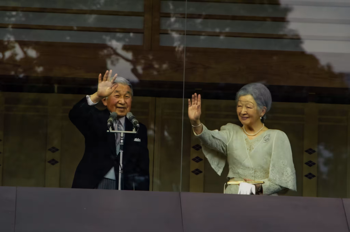 Emperor Akihito and Empress Michiko wave from the balcony of Chowaden Hall.