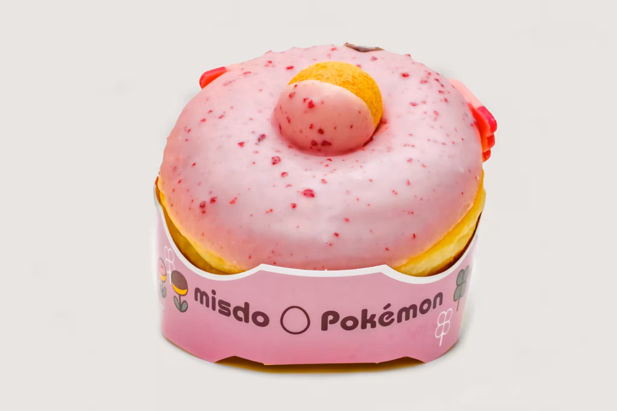 A pink Chancey donut sits in a pink containter on a white background.