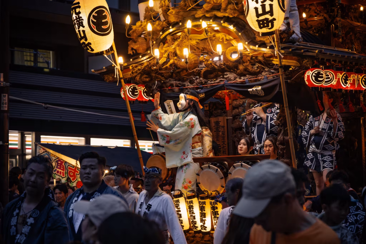 A dancer and musician on a festival float.