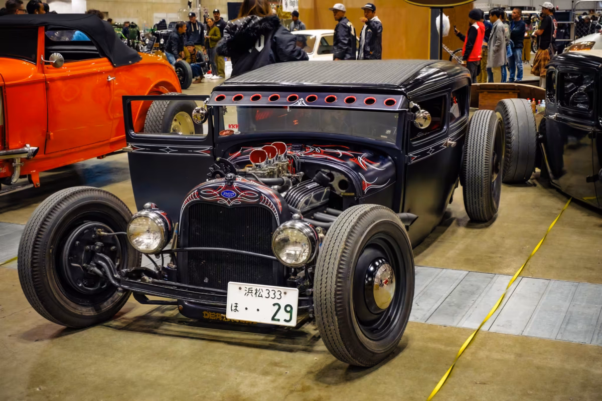 A Ford rat rod car at a car show.