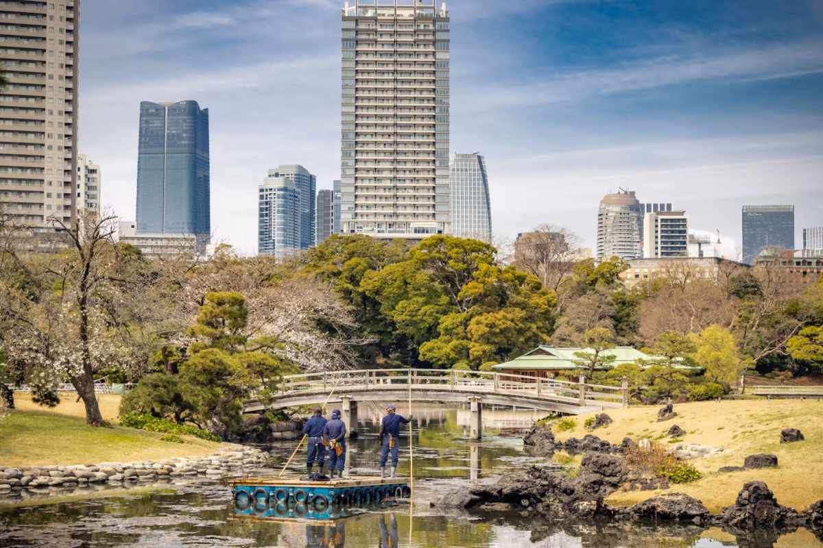 Workmen pole their way through a waterway in Hamarikyu Gardens.