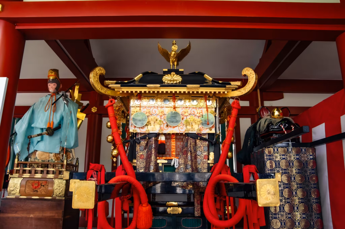 A mikoshi sits under a roof at Hie Shrine.