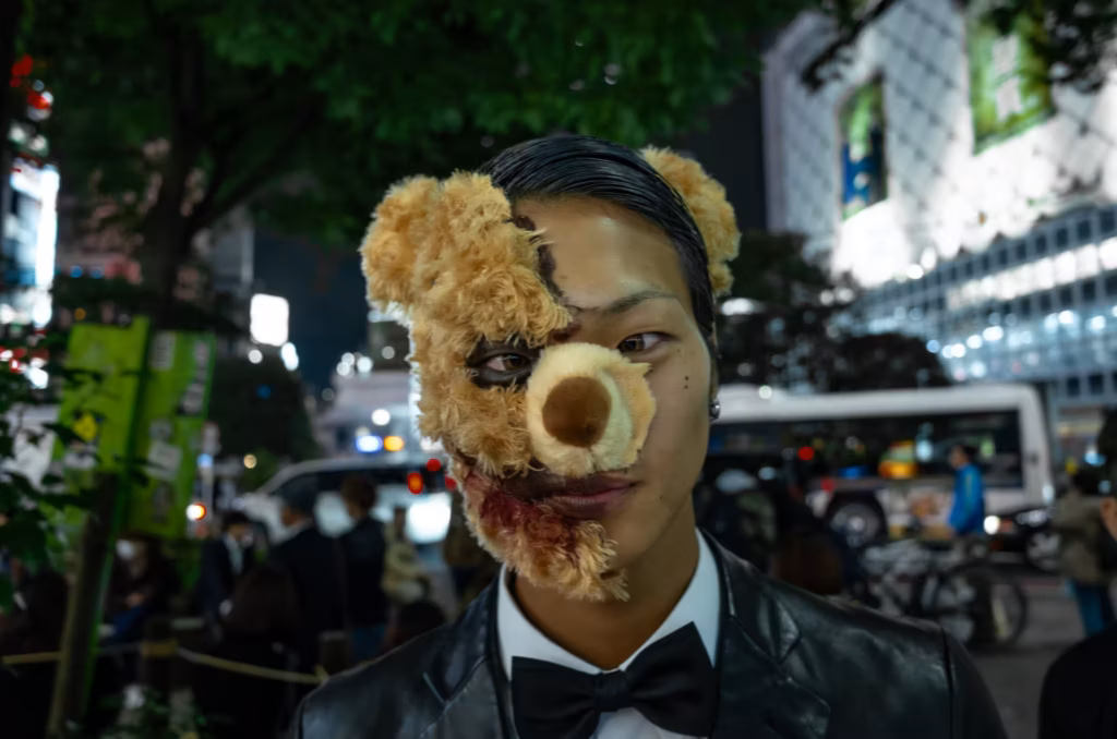 A male cosplayer dressed as half-bear and half-man with a bloody face.