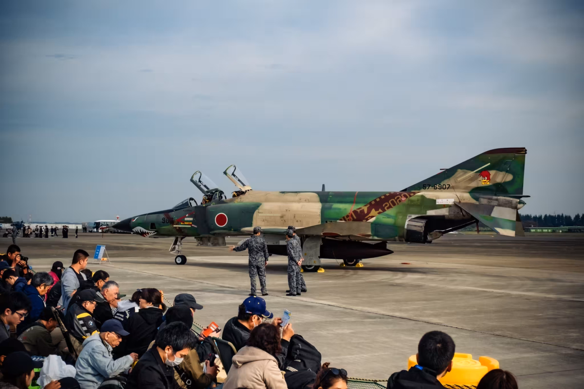 People look at an RF-4EJ reconnaissance aircraft.