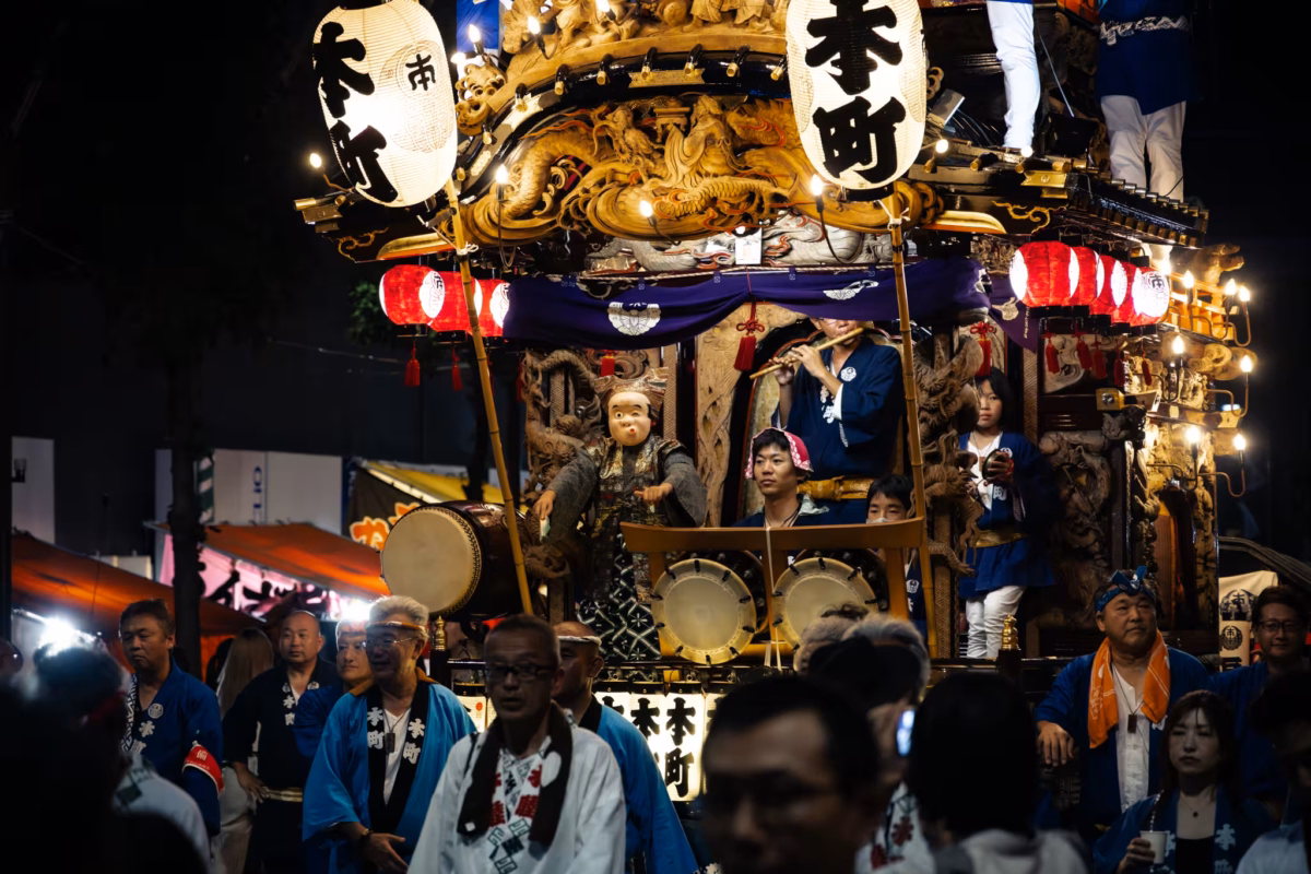 Musicians play on a float at night.