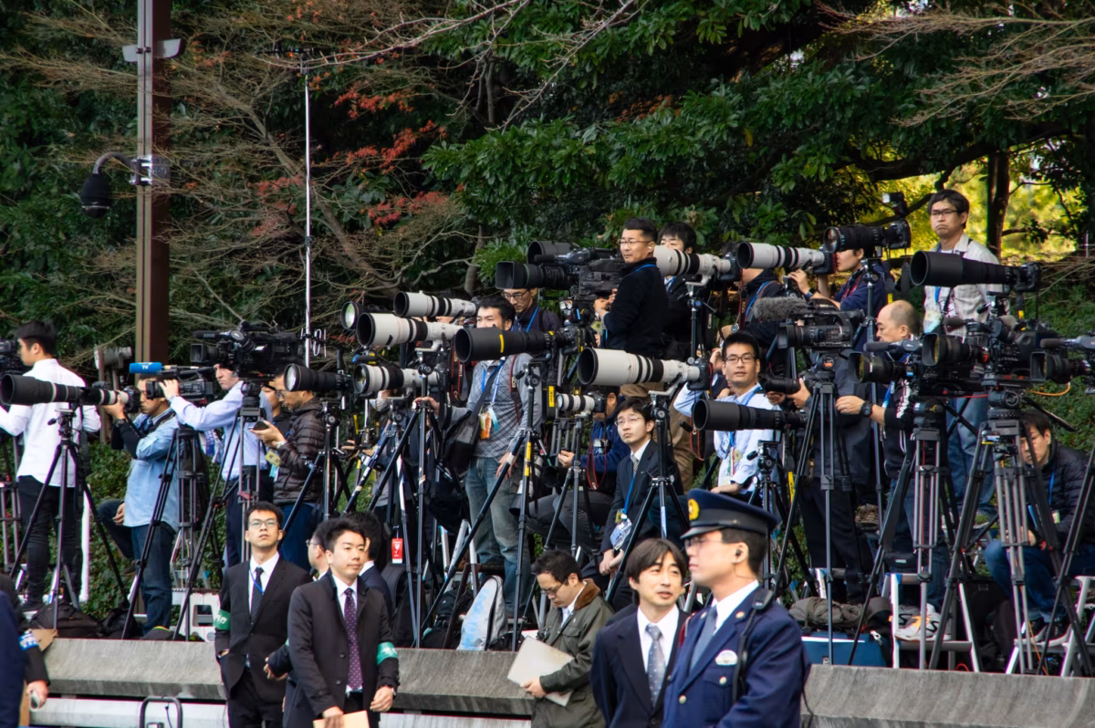 Japanese photographers on a raise platform wait for the Japanese Emperor to appear.