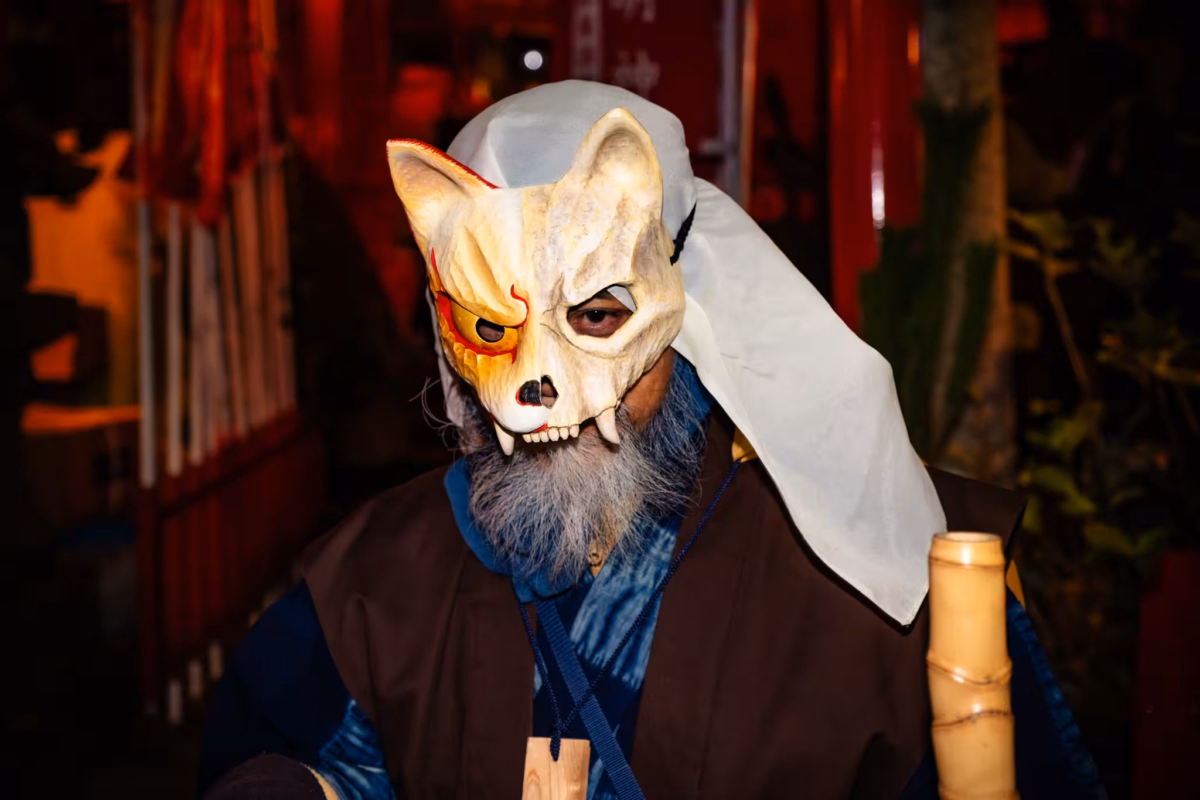 Man in fox mask and kimono.