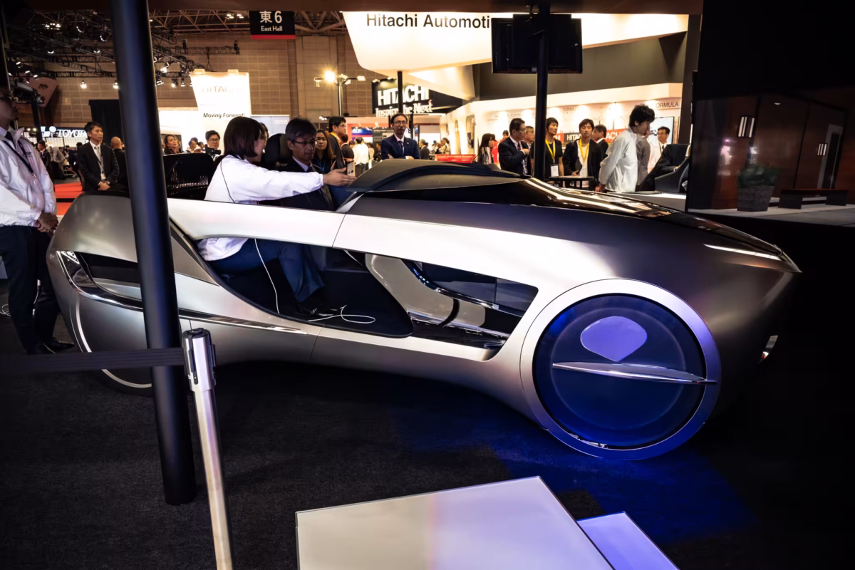 People examing a silver Mitsubishi Emirai 4 at Tokyo Motor Show 2017.