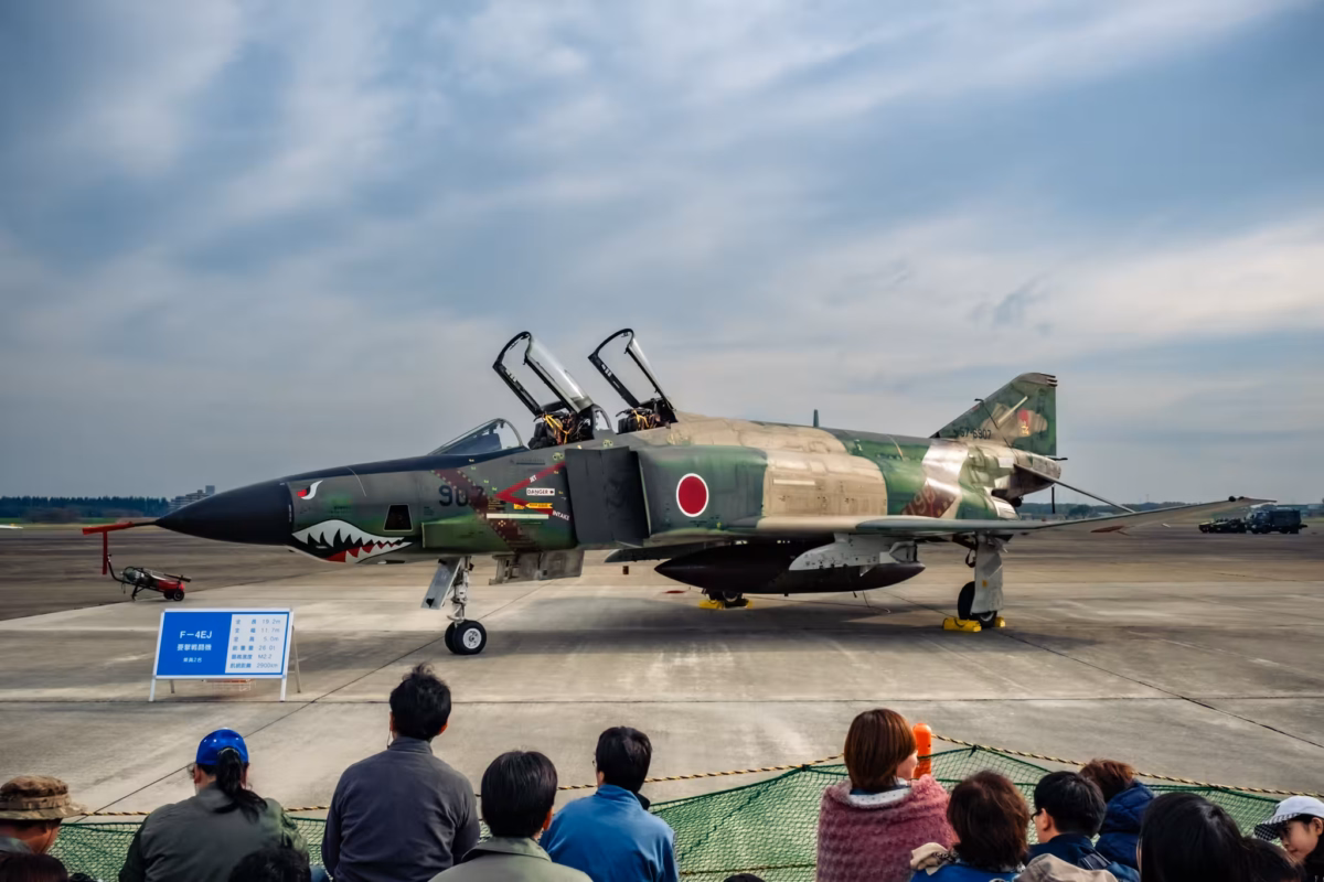 People look at a JASDF RF-4EJ reconnaissance aircraft.