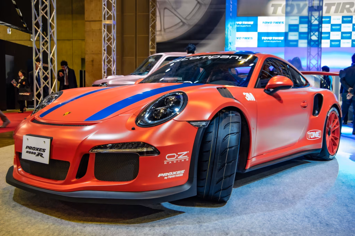 A red Porsche 911 GTR 3RS at a Japanese car show.