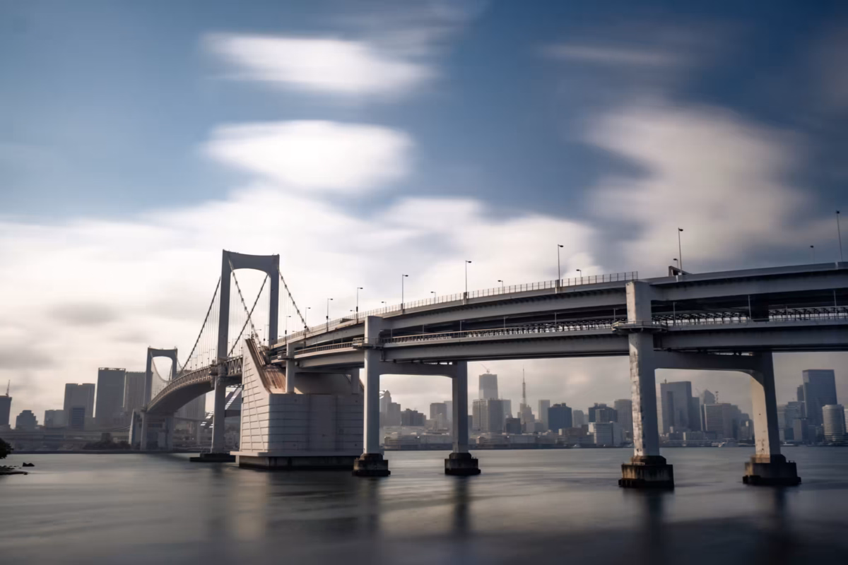 Clouds streak over Rainbow Bridge during a long exposure photograph.