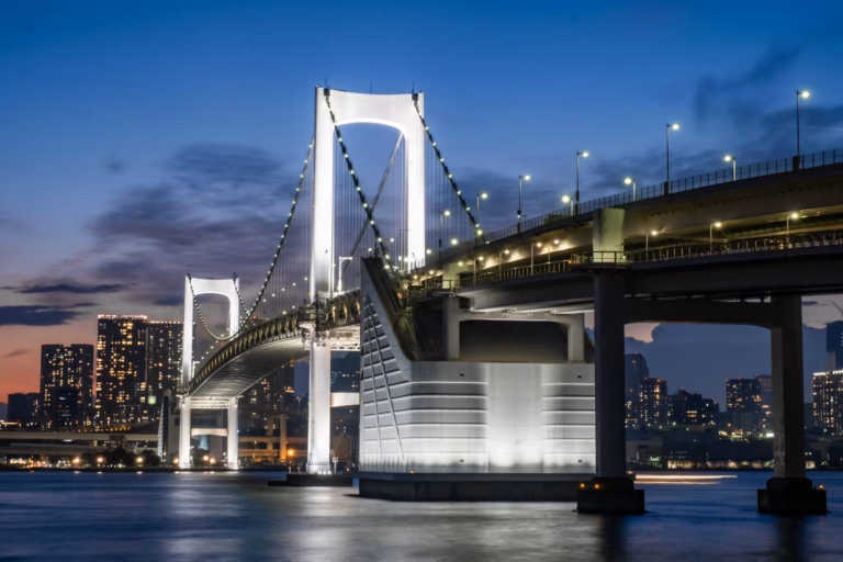 Rainbow Bridge illuminated in the evening, seen from Daiba Island.