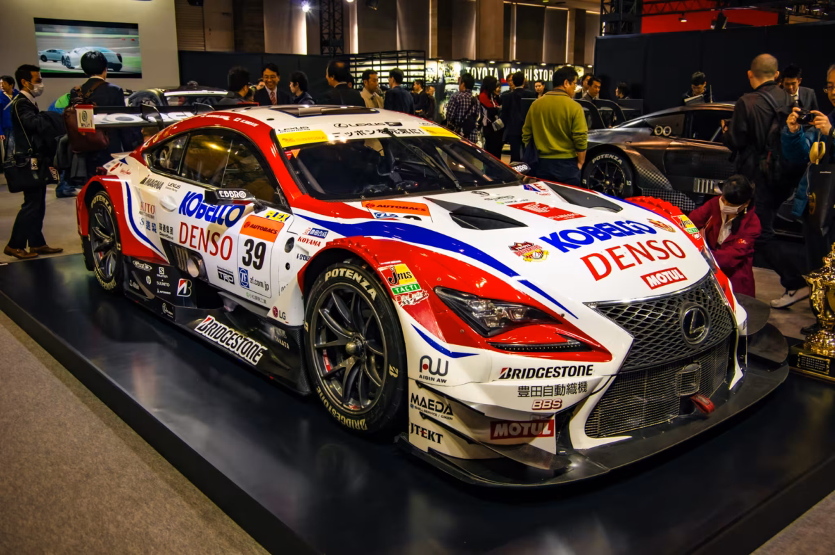 A Super GT Denso Lexus on the crowded display floor of Tokyo Auto Salon 2017.