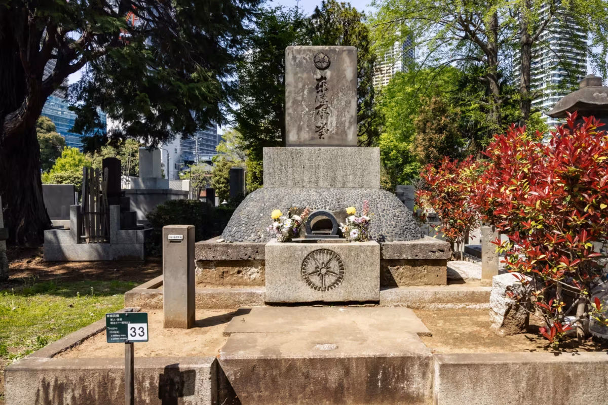 Withered flowers decorate the grave of Tojo Hideki at Zoshigaya Cemetery.