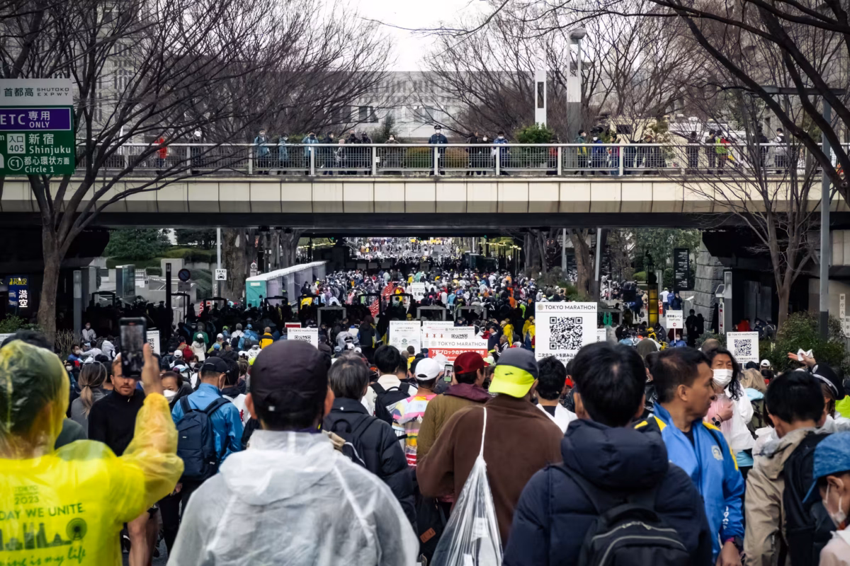 People arrive before the start of Tokyo Marathon 2023 on an overcast day.