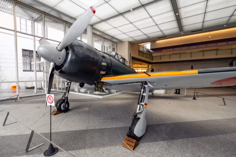 An A6M Zero fighter aircraft sits in the lobby of the Yushukan Museum.