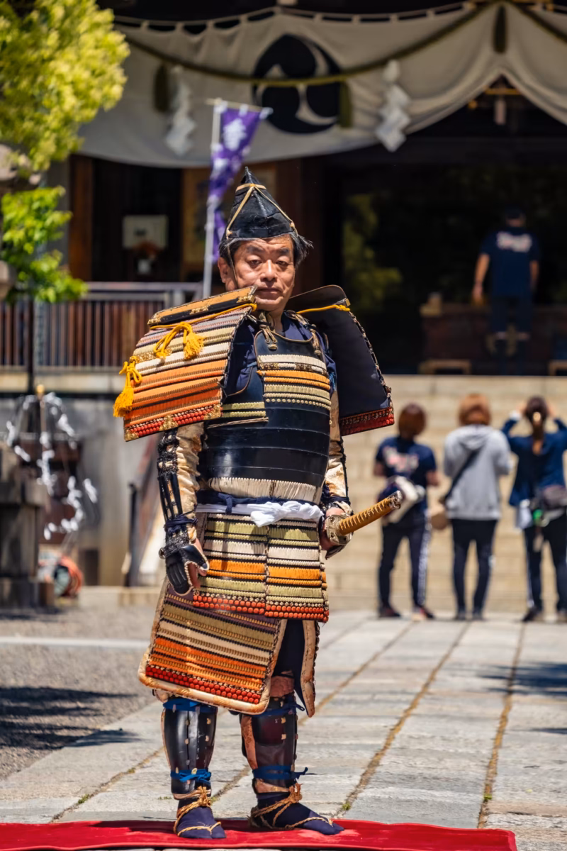 A Heian-period samurai cosplayer stands in front of Kameido Katori Shrine.
