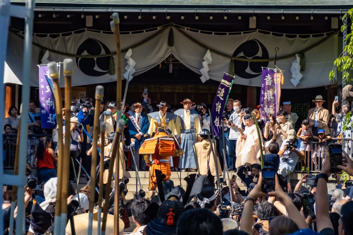 People stand before Kameido Katori shrine to celebrate the end of the Kachiya Matsuri parade.