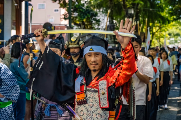 A samurai reenactor holds a katana above his head during the Kachiya Matsuri samurai parade.