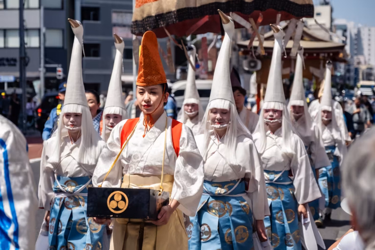 Shirasagi-no-mai dancers in heron headpieces walk in the Daigyoretsu procession through the streets of Tokyo.
