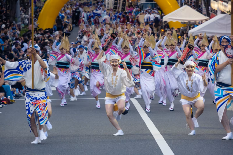 Dancers in traditional attire and straw hats perform an energetic street parade for the Koenji Awa Odori.