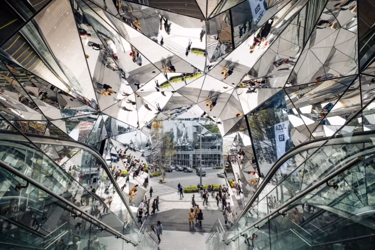 Reflective kaleidoscope entrance at Tokyu Plaza Omotesando Harajuku with multifaceted glass mirrors.
