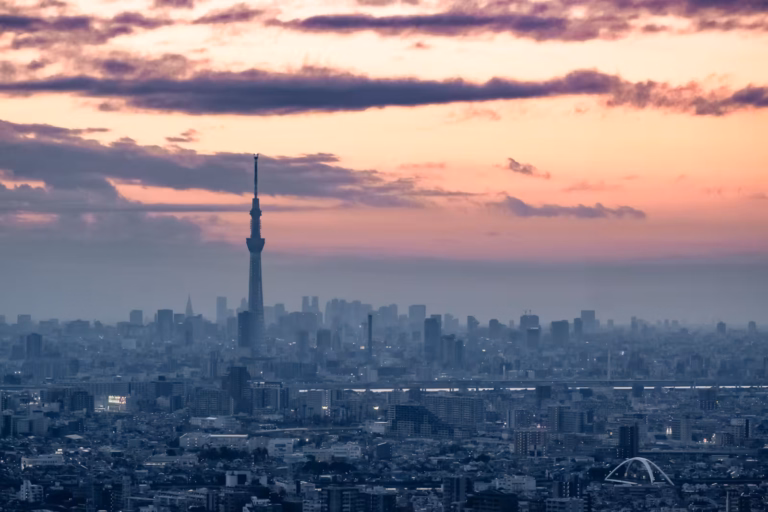 Japan's Tokyo Skytree silhouetted against a purple and pink twilight sky, viewed from the I-Link Tower.