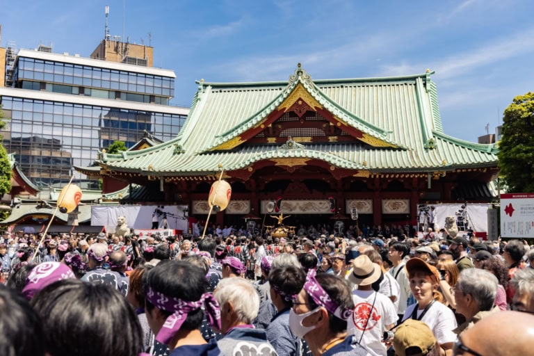 A large crowd gathers at Kanda Myojin Shrine during the Kanda Matsuri in Tokyo.