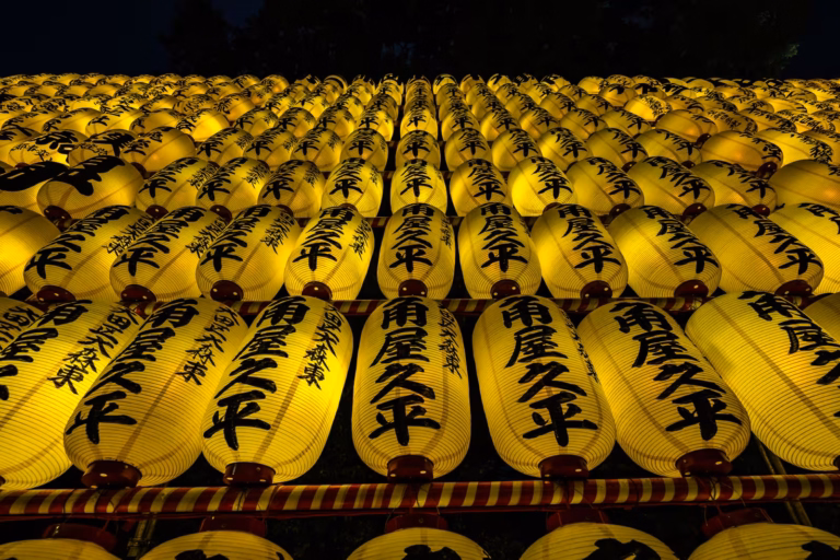 Rows of glowing yellow lanterns with black calligraphy, captured with a Fujifilm XF 10-24mm F4 R OIS lens.