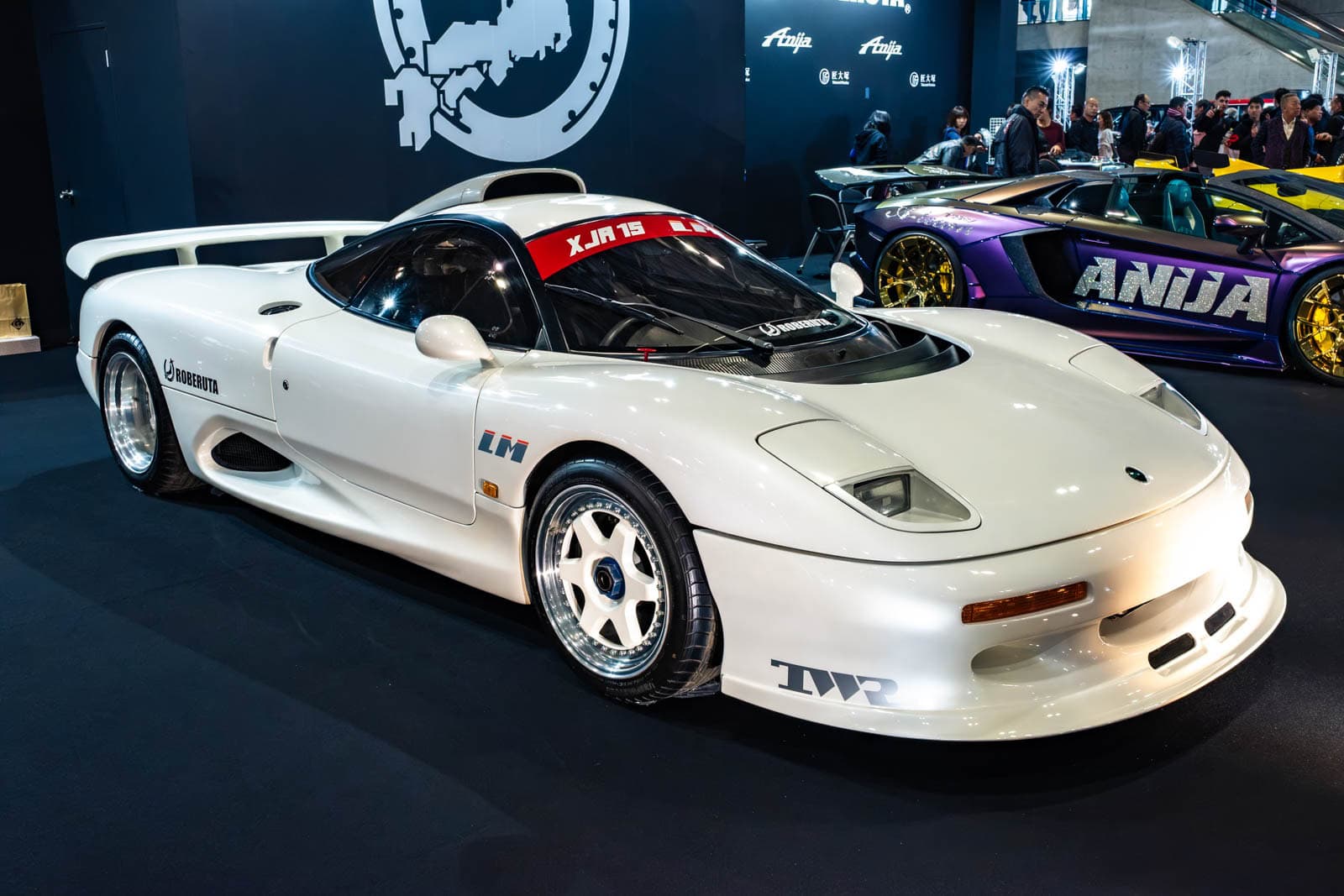 Jaguar XJR-15 at Tokyo Auto Salon 2020, shown with background Aniija signage and a purple supercar.