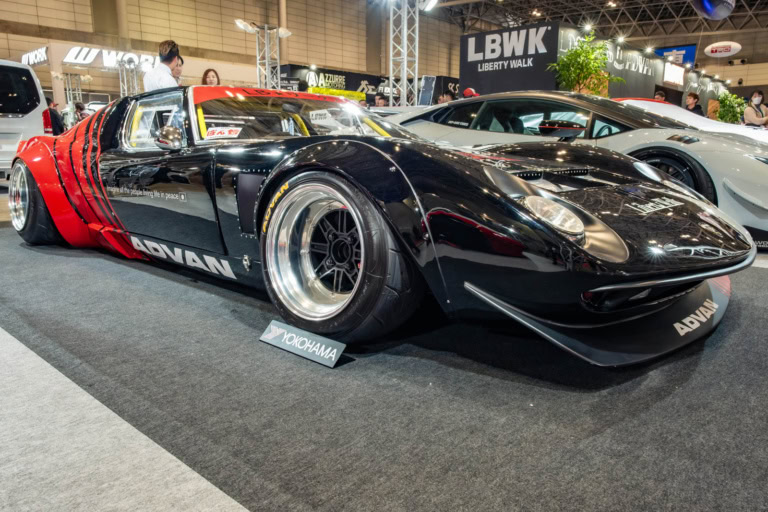 Liberty Walk Miura at Tokyo Auto Salon 2020, shown with background LBWK signage and other cars.