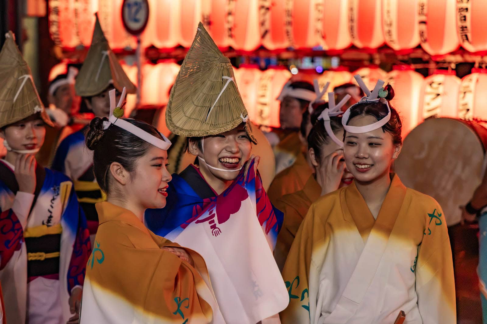 Smiling dancers in traditional attire and straw hats perform at the Hatsudai Awa Odori.