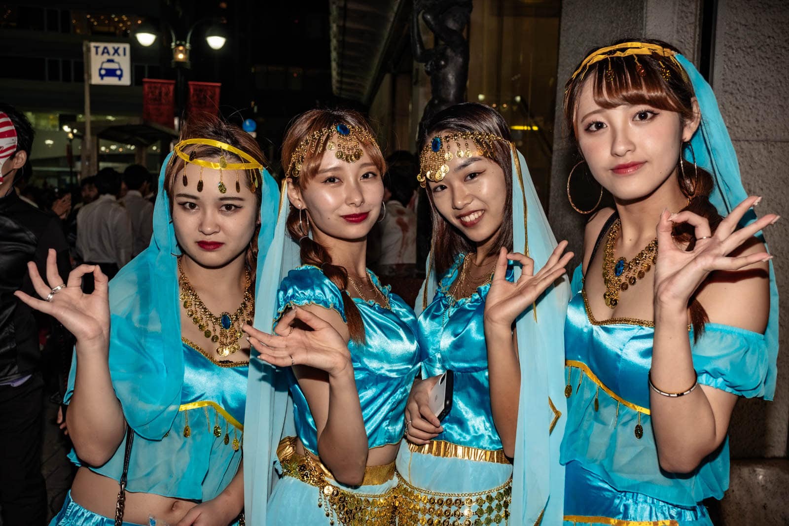 Four women wearing matching blue Arabian princess costumes during Halloween in Shibuya.