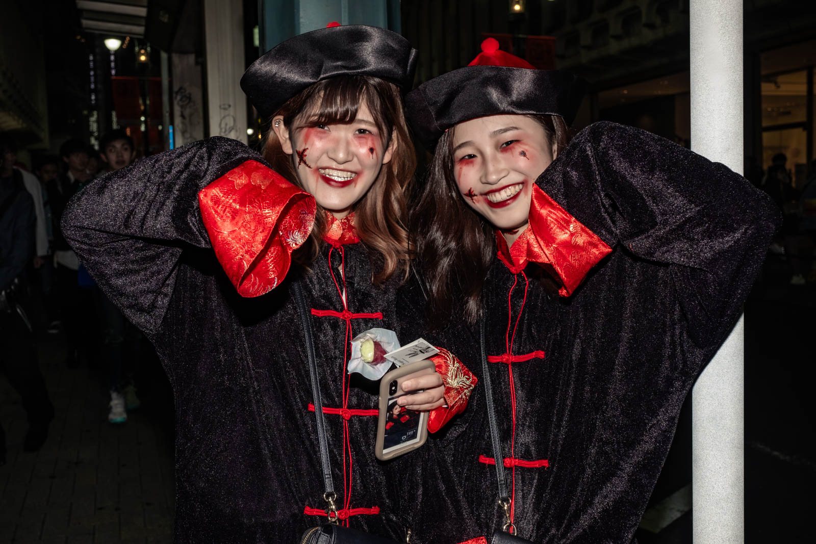 Two female Chinese Kyonshi vampire cosplayers at a Shibuya Halloween street party.