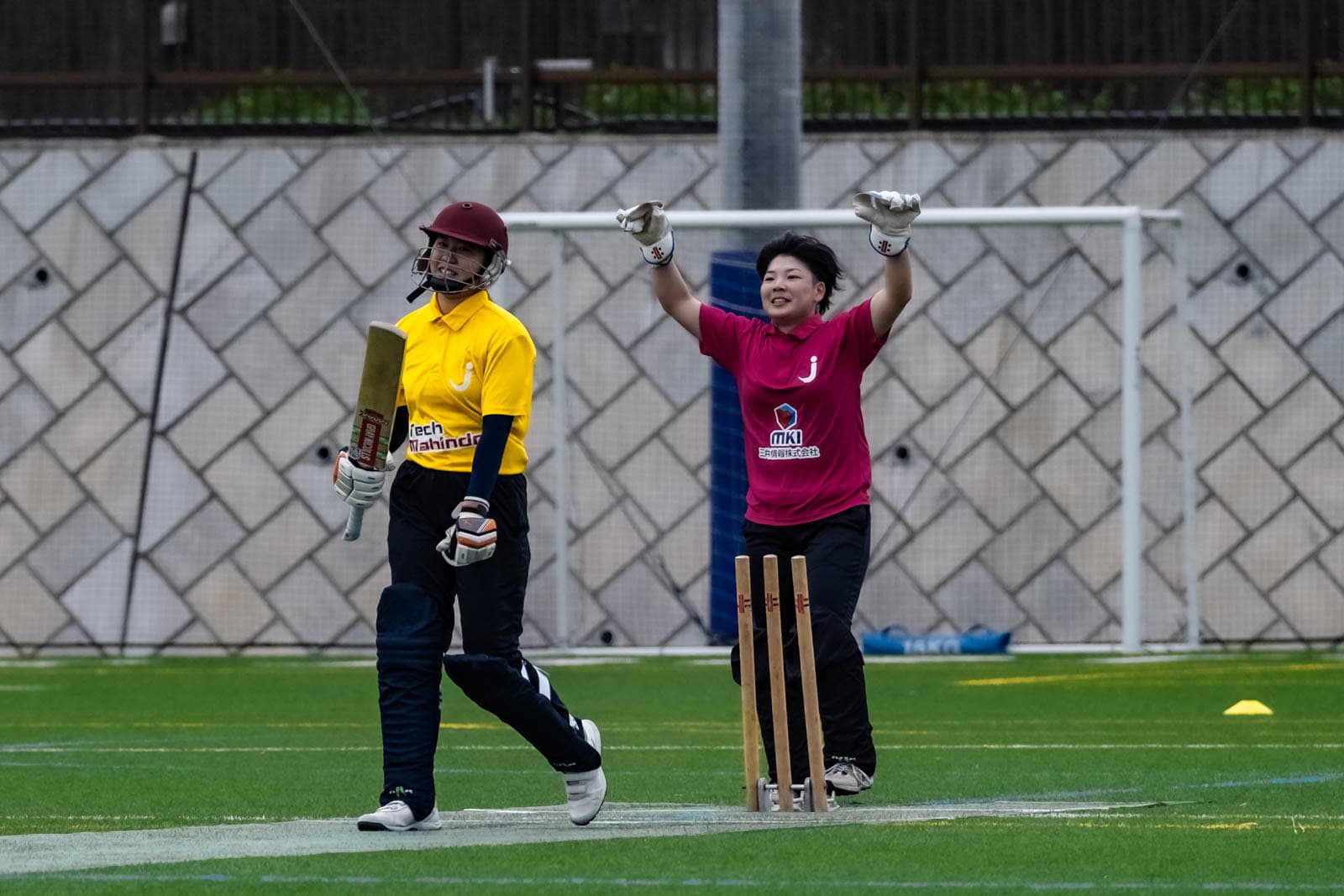 A Japanese cricket wicketkeeper celebrates the dismissal of a batter at BST Nagasawa Sports Ground in Kanagawa Prefecture.