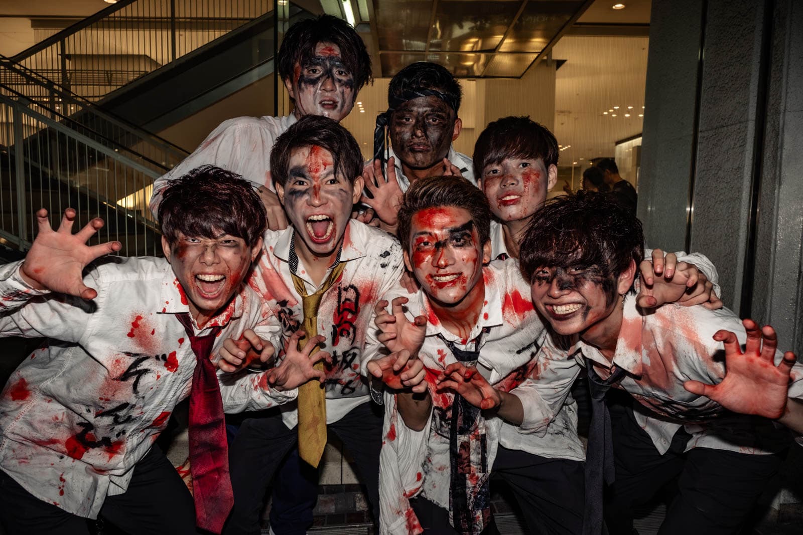 Japanese zombie high school student cosplayers at Shibuya Halloween street party.