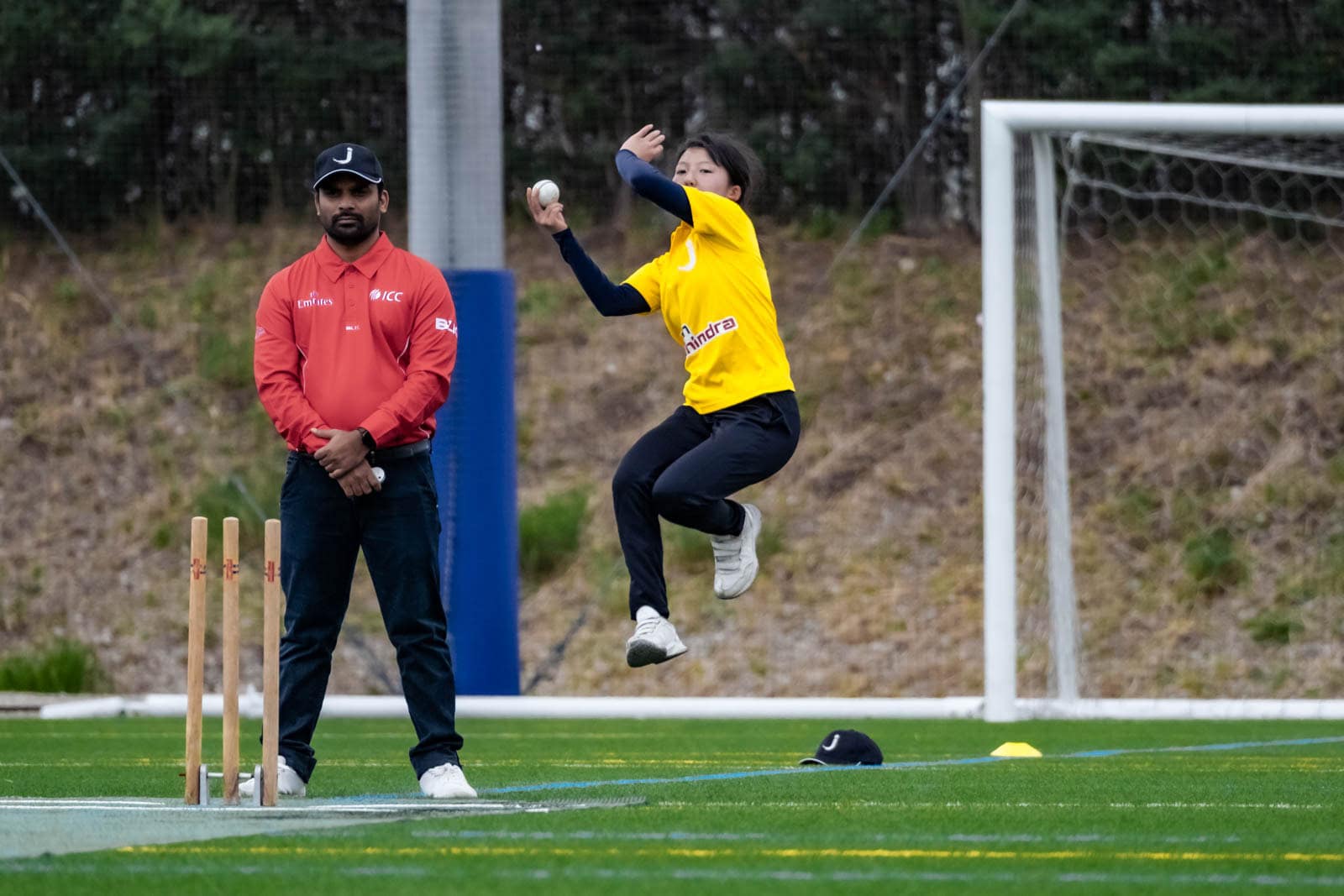 A Japanese bowler leaps in the air mid-delivery during a J-BASH cricket match in Kanagawa Prefecture.