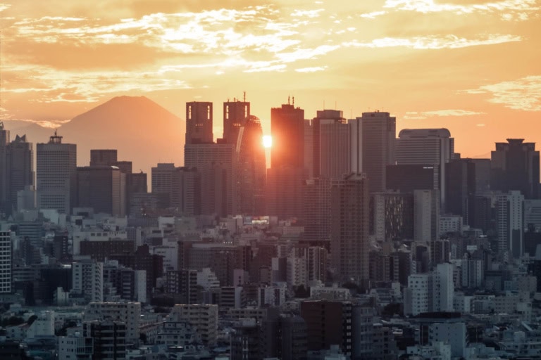 Bunkyo Civic Center Observation Lounge view of Shinjuku skyscrapers and Mount Fuji at sunset.
