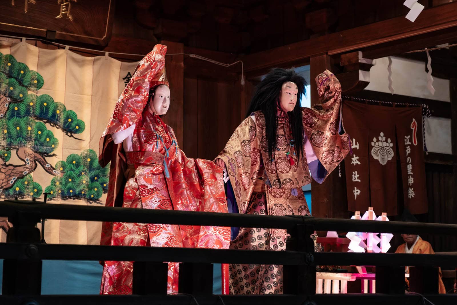 Performers in traditional costumes and masks give a stage performance at Okunitama Shrine during the Tori-no-Ichi festival.