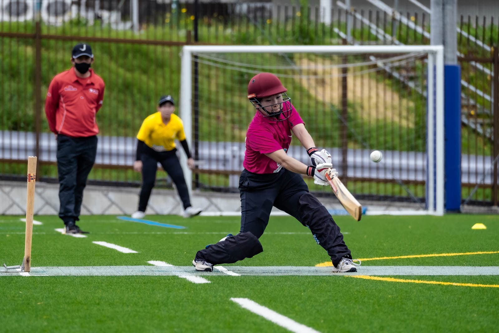 A batter plays a pull shot during a Japanese women's cricket match in Kanagawa Prefecture.
